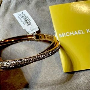 Beautiful gold, Michael Kors bangle bracelet with diamonds on the front.